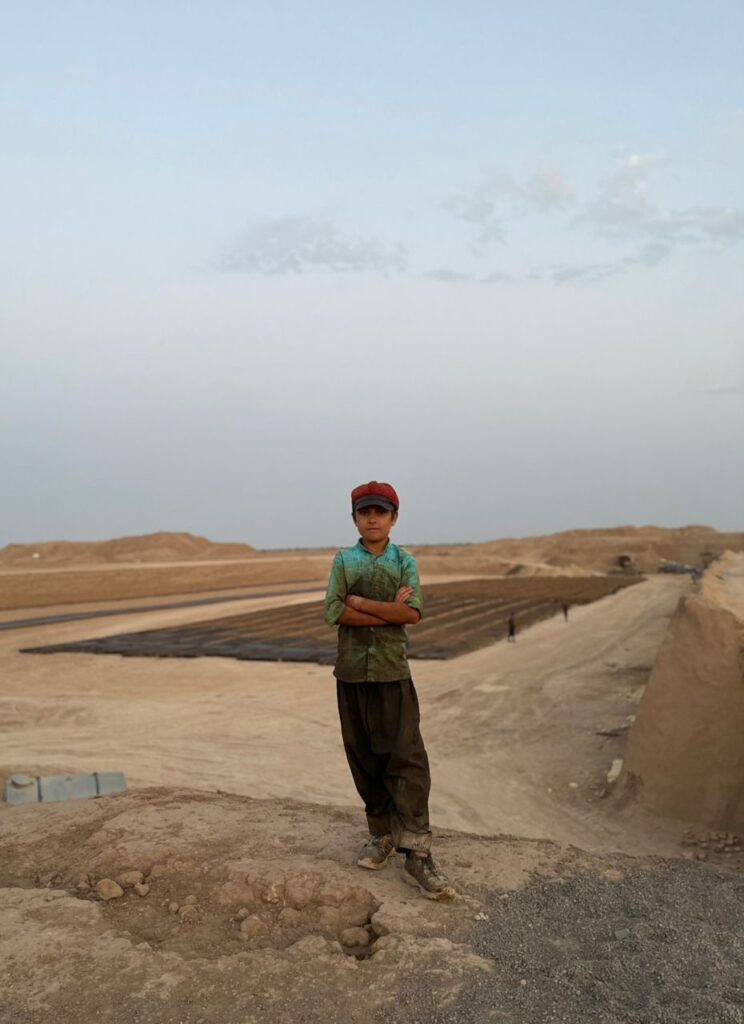 Iranian boy standing near kiln house